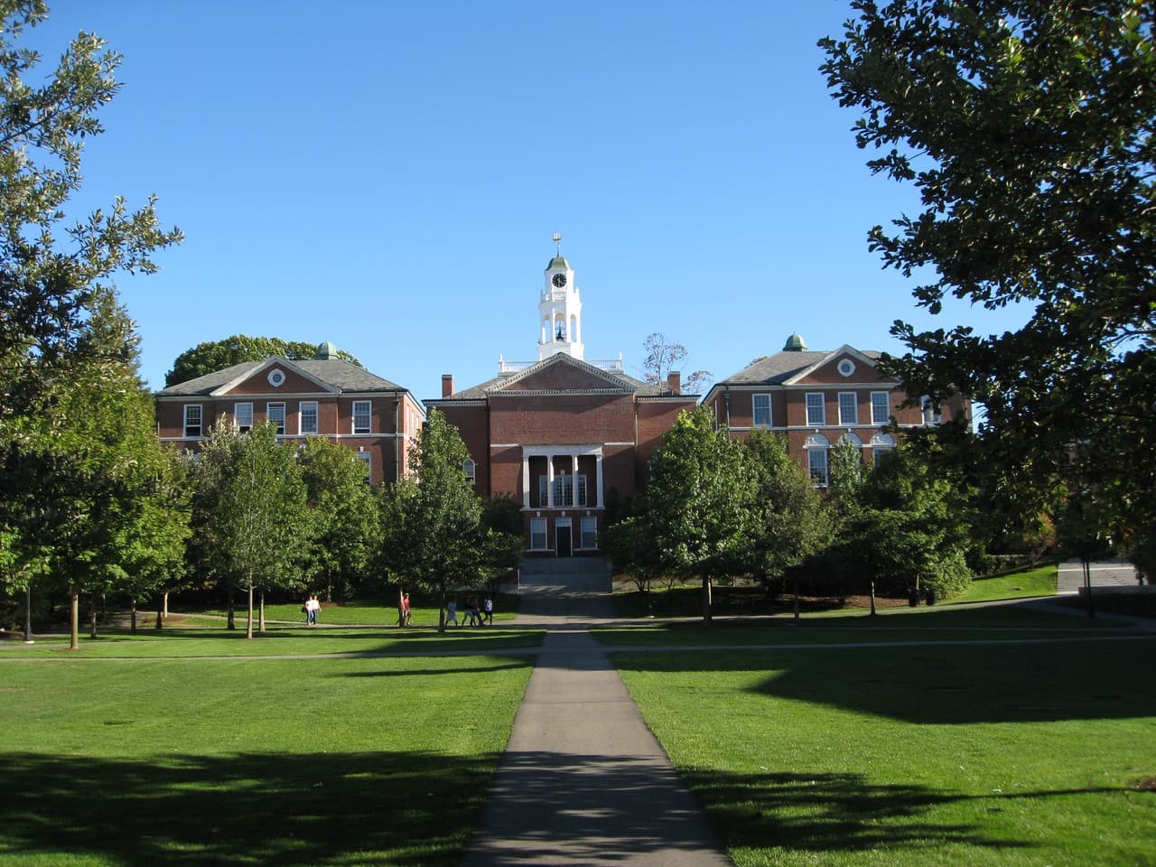 Phillips Exeter Academy building, with a white cupola above its brick facade and a lawn in front