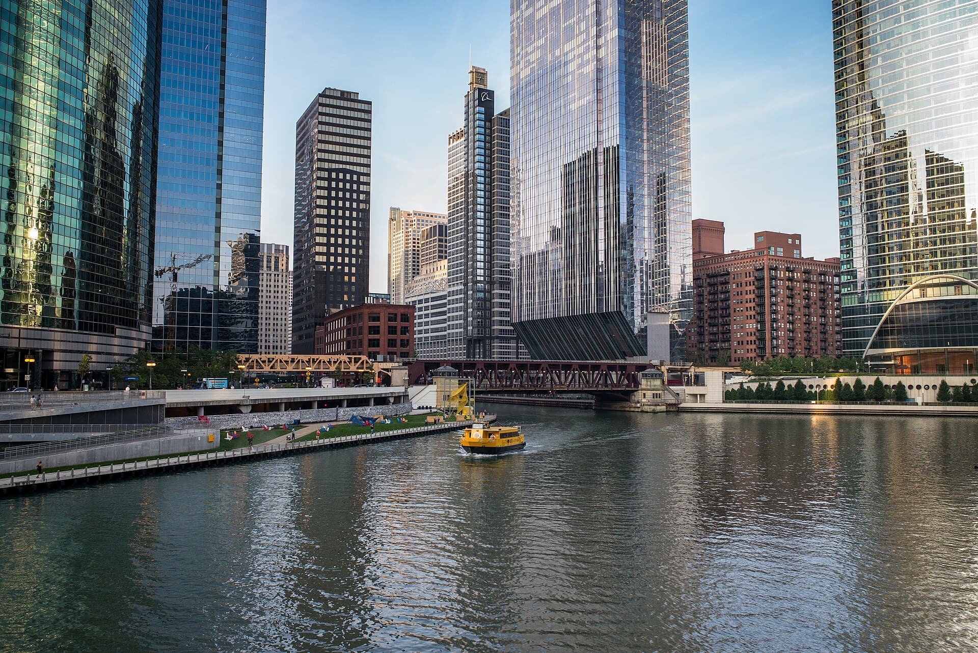 Office towers and a water taxi on the Chicago River on a clear morning