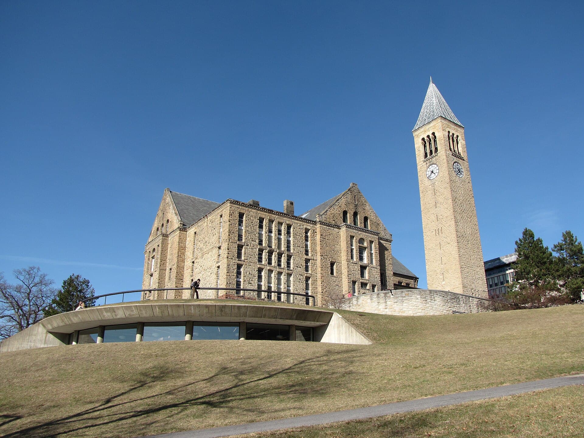 McGraw Tower and Uris Library on Cornell’s campus under a clear blue sky