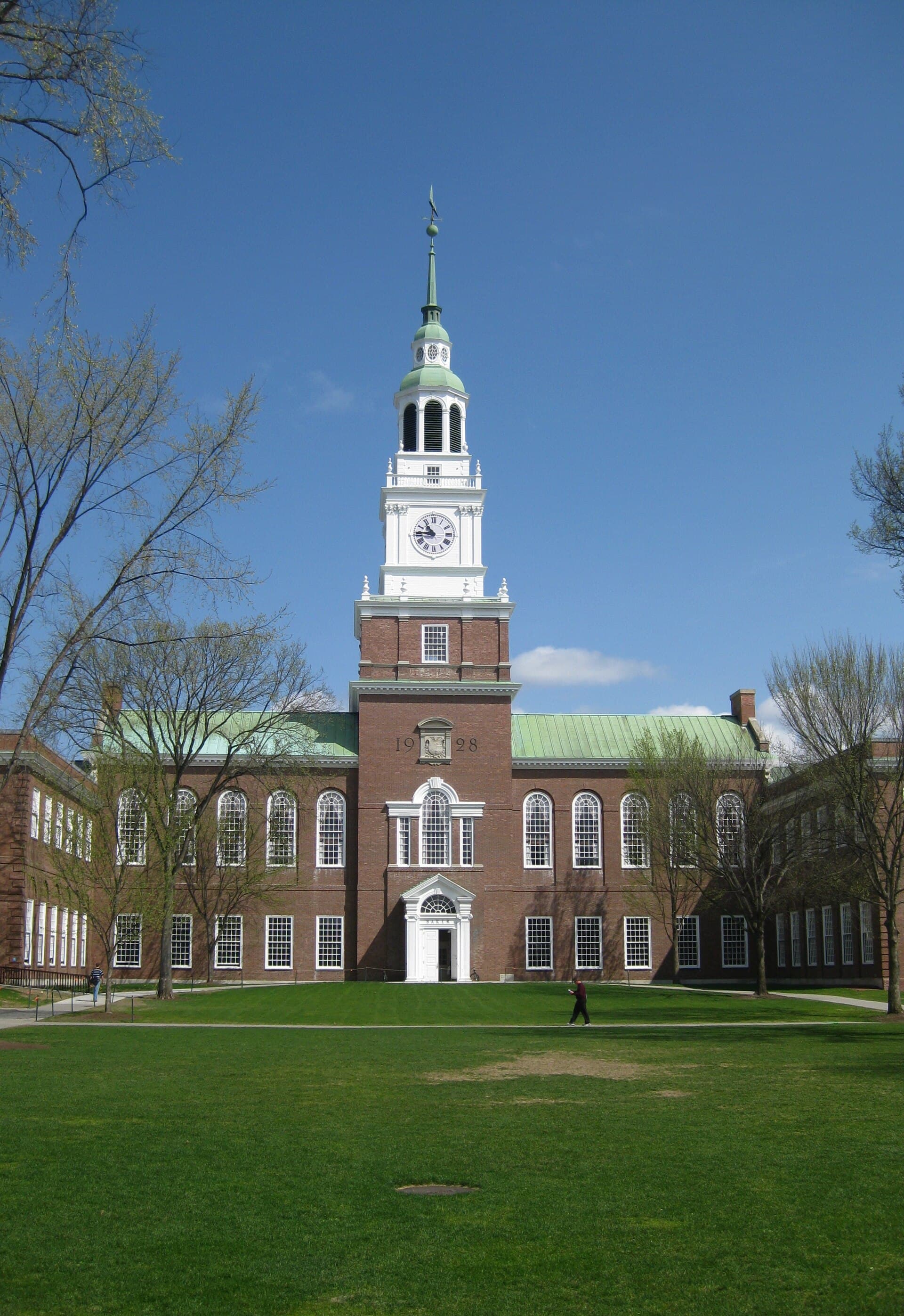 Baker Library at Dartmouth College, a brick building with a tall white clock tower above a green lawn