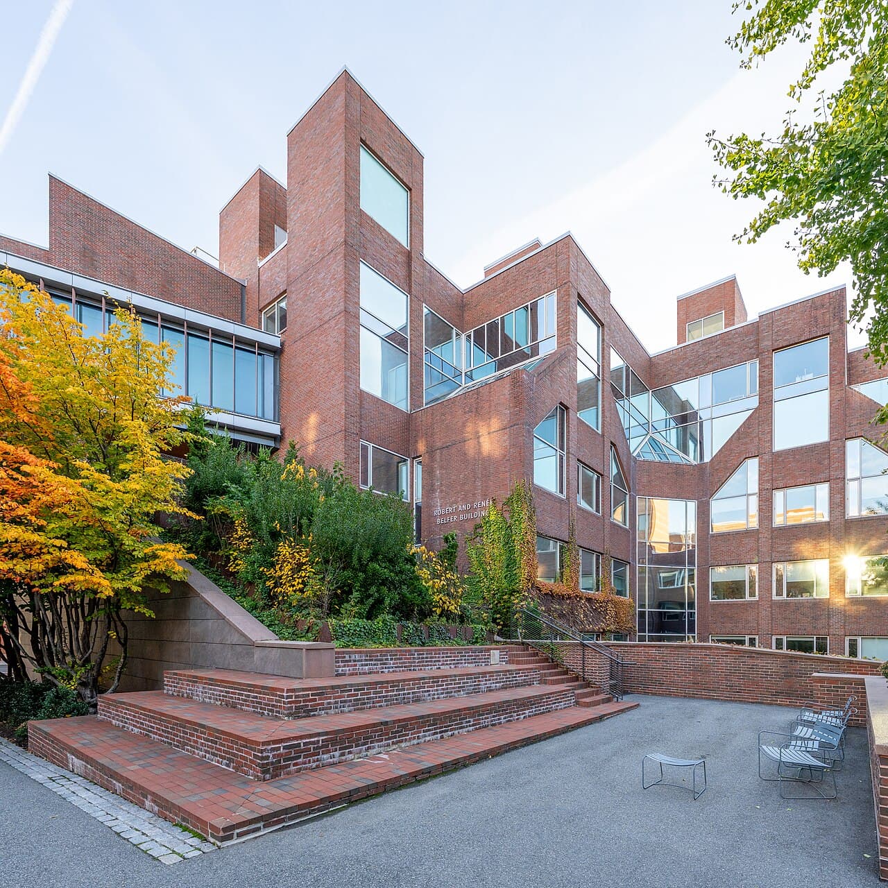 The brick Belfer Building at Harvard Kennedy School, with autumn trees and outdoor steps