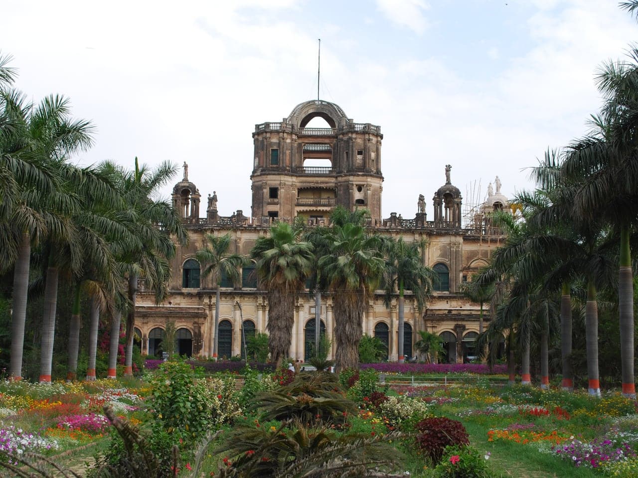 La Martiniere College in Lucknow, seen down a path of palm trees and flower beds