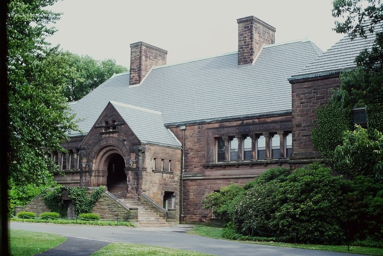Memorial Hall at the Lawrenceville School, framed by trees and campus paths