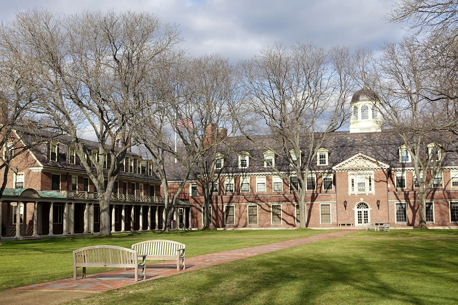 Brick buildings around the Grubbs Quadrangle at the Loomis Chaffee School, with benches and bare trees