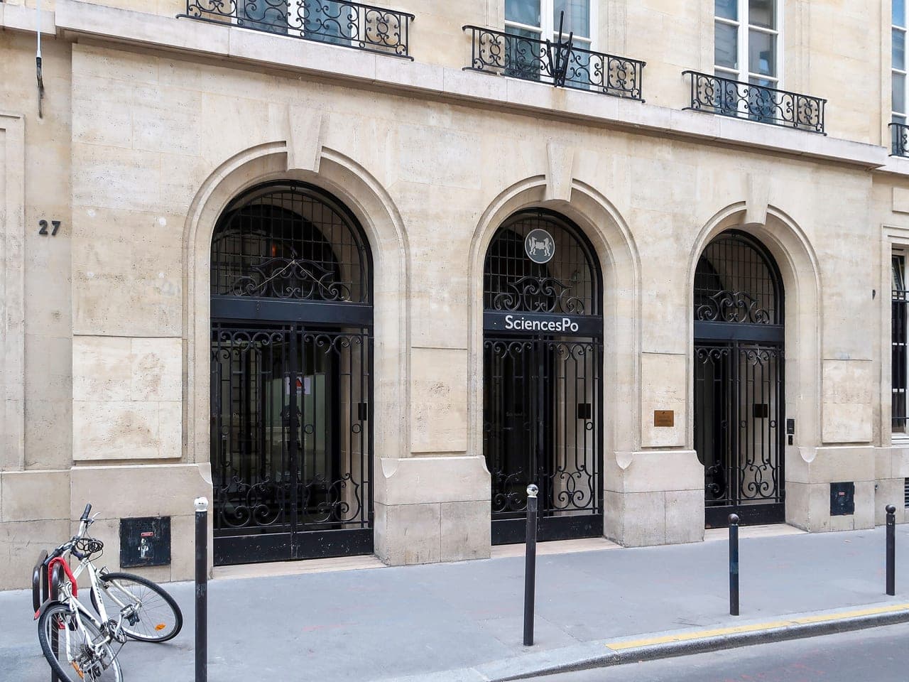 The arched stone entrance of Sciences Po at 27 rue Saint-Guillaume in Paris