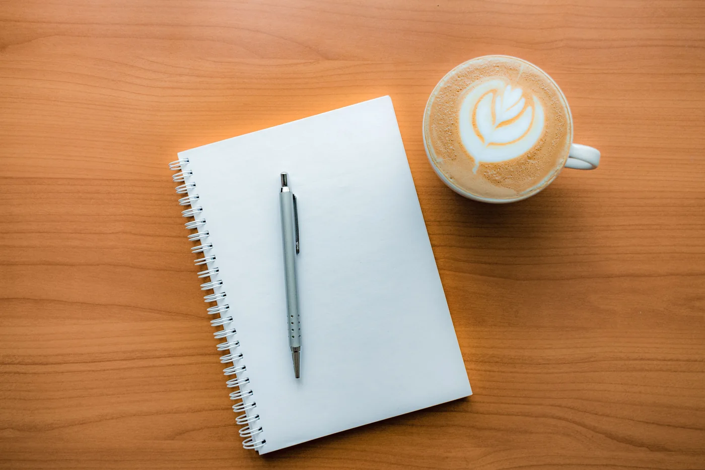 Notebook and coffee prepared for an advisory conversation